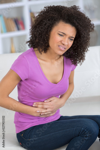 woman suffering from abdominal pain photo