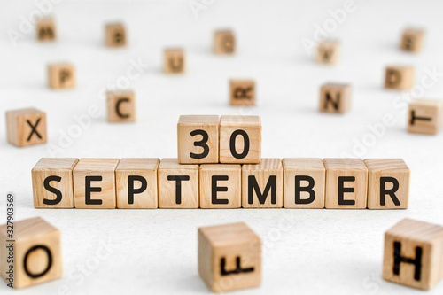 September 30 - from wooden blocks with letters  important date concept  white background random letters around