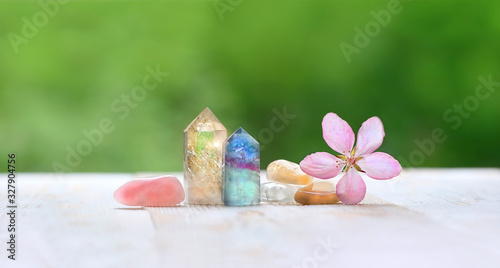 fluorite  citrine  pink quartz and flower. gemstones crystal minerals for relaxation and meditation. Healing Crystal Ritual. copy space
