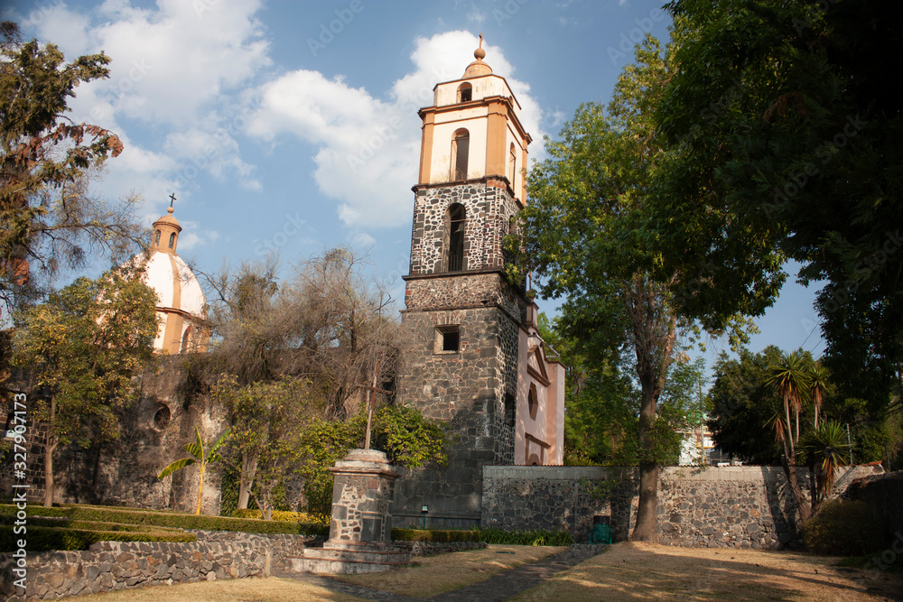 View of the towers and parts of the dome of the former Culhuacán convent in Mexico City wonders among the city