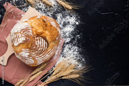 freshly baked bread on a dark background. With copy space. View from above.