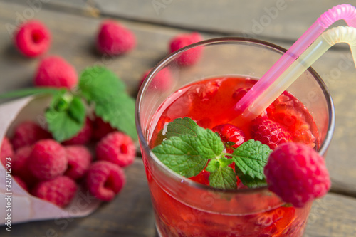 Glass of fresh strawberry smoothie and fresh strawberries on the wooden background. Healthy food and drink concept.