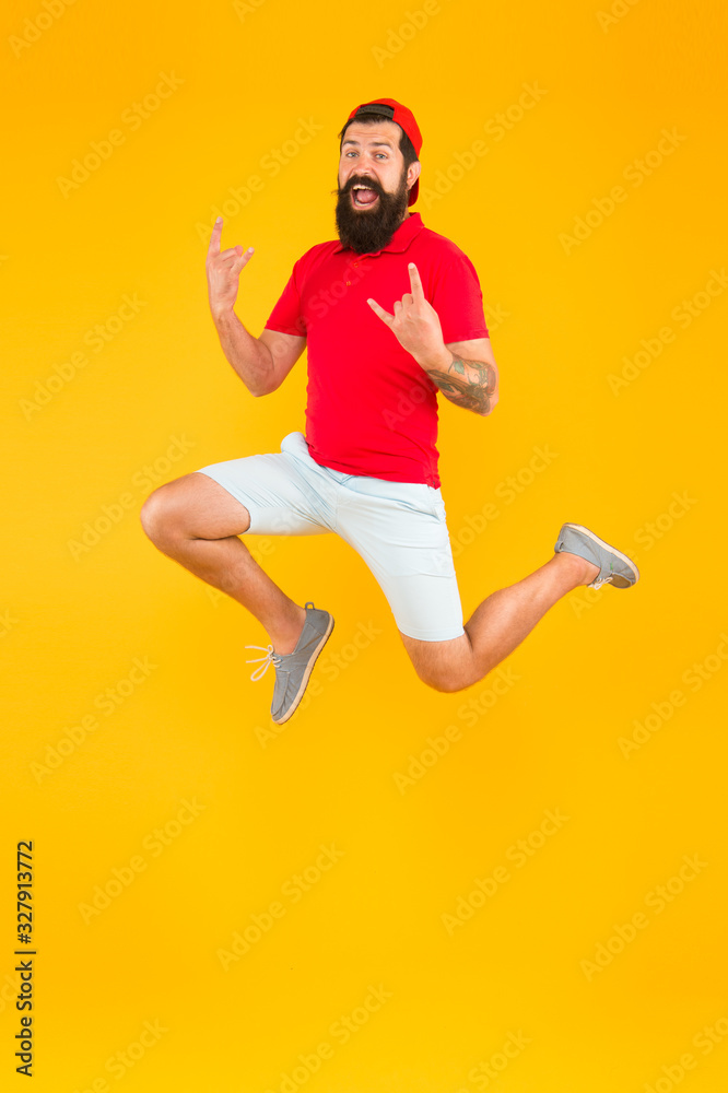 Energy charge. Healthy guy feeling good. Inspired concept. Always in motion. Enjoying active lifestyle. Happy guy jumping. Active bearded man in motion yellow background. Active and energetic hipster