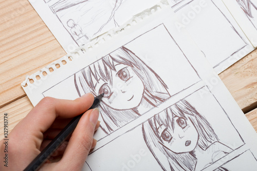 Artist drawing an anime comic book in a studio. photo