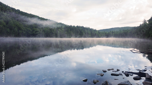 Fototapeta Naklejka Na Ścianę i Meble -  A scenic foggy view of Little Rock Pond along the Long Trail in Vermont.