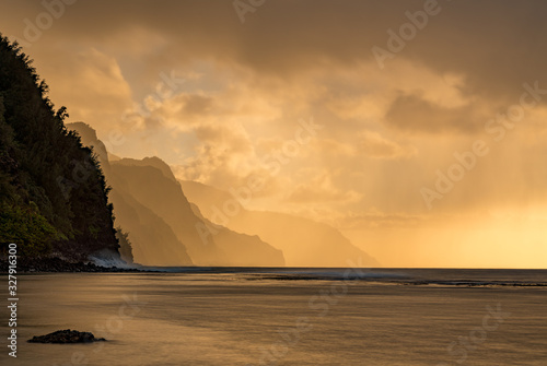 Sunset lights the receding cliffs of the NaPali coastline on north coast of Kauai in Hawaii