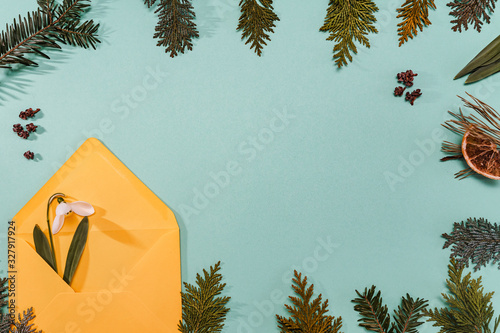 Spring time, Increasing position of snowdrops on a turquoise background, top view, modern and simple decor