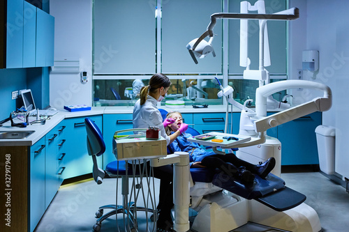 Young female dentist working in her office.