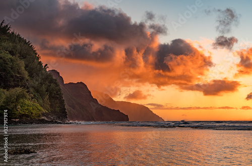 Sunset lights the receding cliffs of the NaPali coastline on north coast of Kauai in Hawaii photo