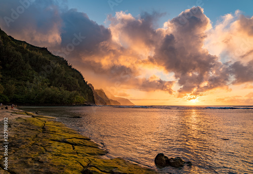Sunset lights the receding cliffs of the NaPali coastline on north coast of Kauai in Hawaii