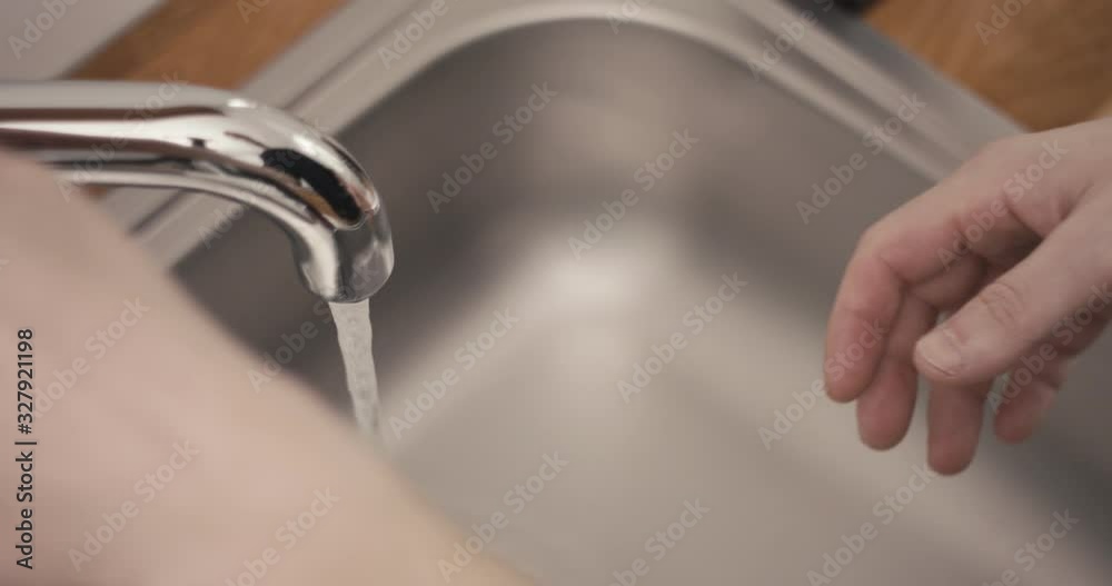 Man washing hands the best way at home coronavirus rinse water rub soap extreme close up slow motion