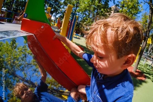 Happy boy on playground, su...