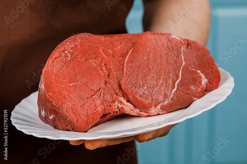 Raw beef for cooking steak on a white plate