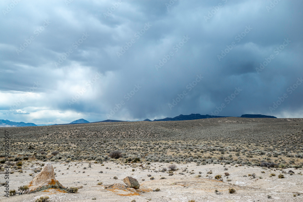 A rare rain storm fills the sky with dark clouds over sagebrush hills in the White River Valley, Basin and Range National Monument, Lincoln County, Nevada. A rare rain storm fills the sky with dark clouds over sagebrush hills in the White River Valley, Basin and Range National Monument, Lincoln County, Nevada.