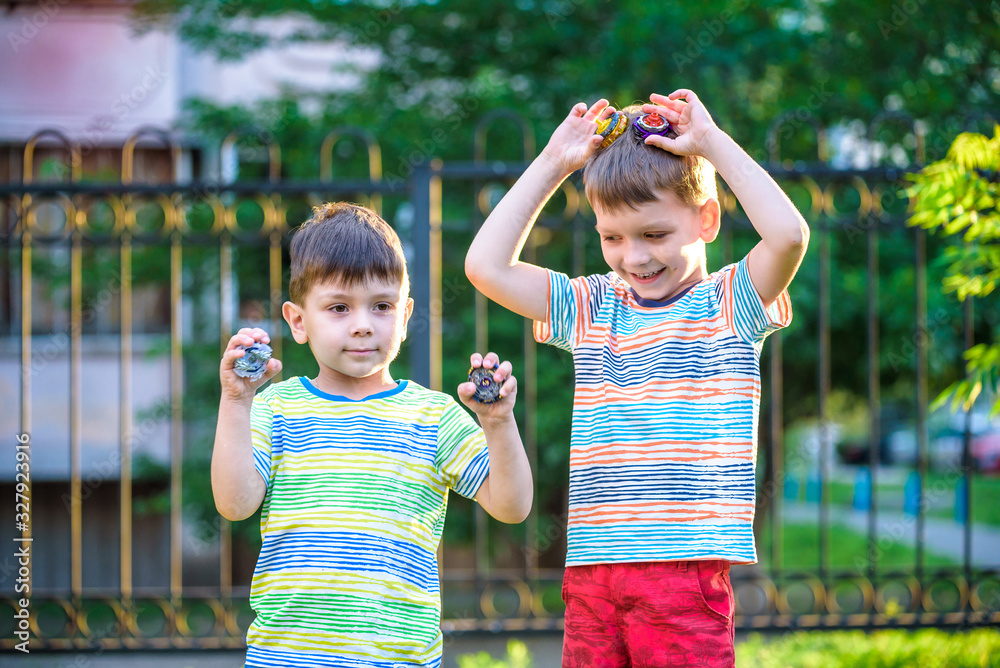two Boy playing with a spinning top outdoors two Boy playing with a spinning top outdoors