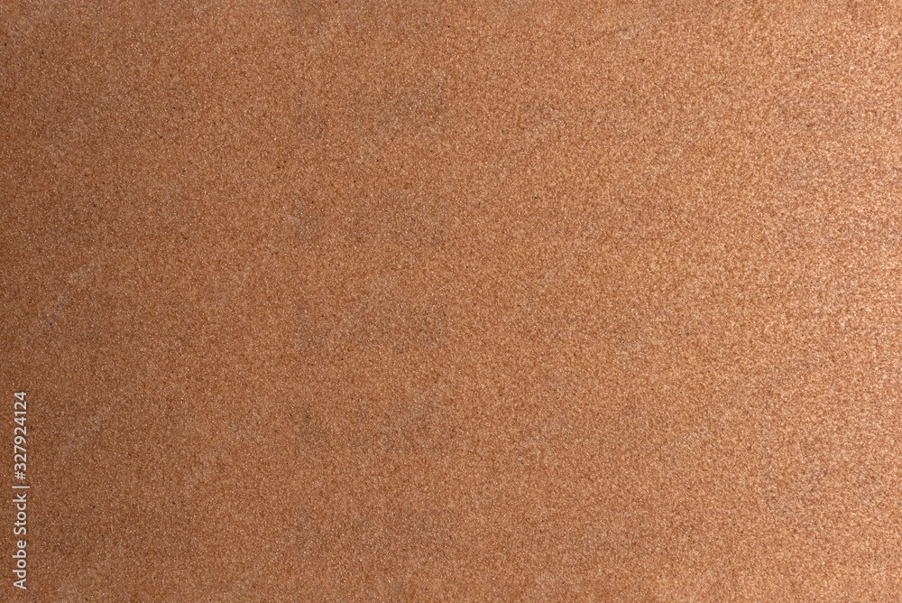 Background made of brown sandpaper, illuminated by a soft light from the right. Background made of brown sandpaper, illuminated by a soft light from the right.