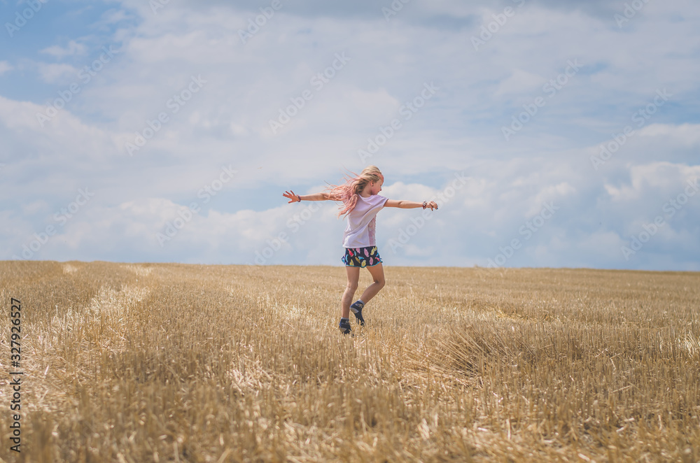little child having fun in agricultural field backview little child having fun in agricultural field backview