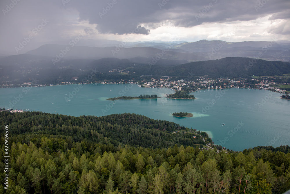 View from Lake Wörther See in the Austrian Alps overlooking a beginning storm with dark clouds and rain