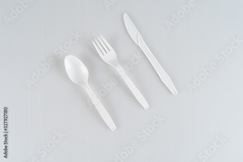 White  plastic  disposable spoon  fork and knife isolated on a white background.
