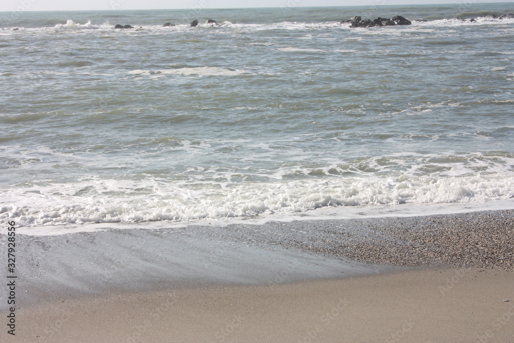 A winter beach with rough seas with cold and dull colors in the Versilian Riviera