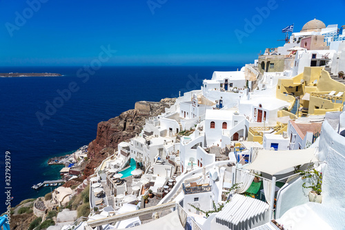 White houses of Oia town on Thira  Santorini  island with colorful volcanic cliffs and deep blue sea.