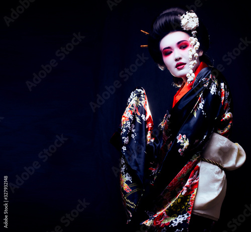 young pretty geisha in kimono with sakura and decoration © iordani