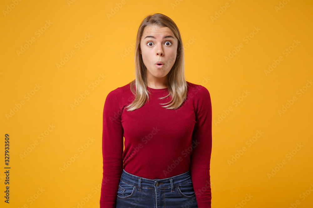 Shocked amazed young blonde woman girl in casual clothes posing isolated on yellow orange background studio portrait. People sincere emotions lifestyle concept. Mock up copy space. Looking camera. Shocked amazed young blonde woman girl in casual clothes posing isolated on yellow orange background studio portrait. People sincere emotions lifestyle concept. Mock up copy space. Looking camera.