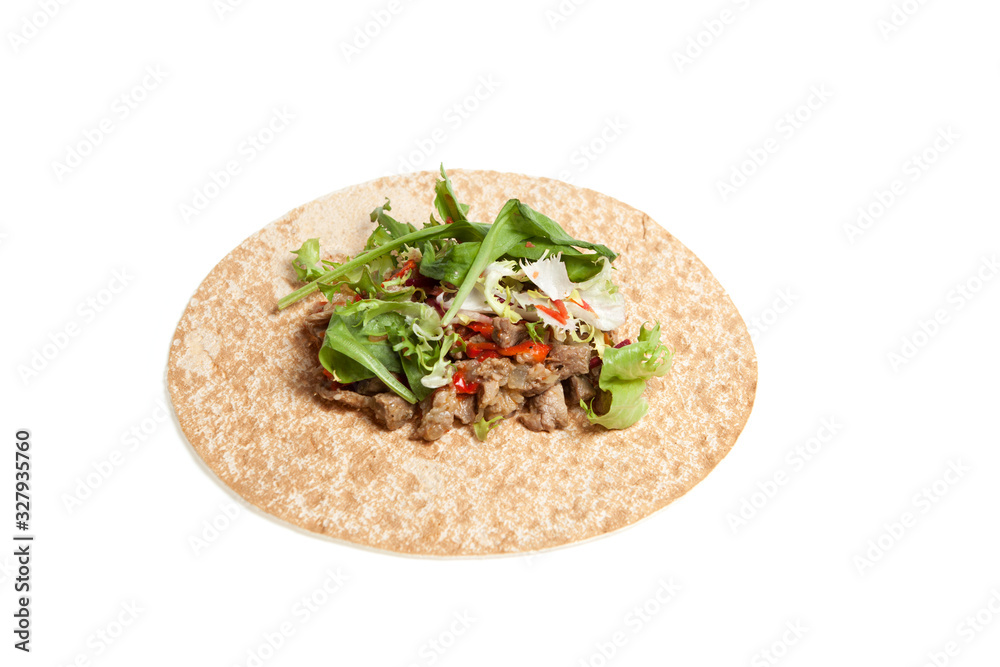 Arabic or Mexican thin bread with meat and vegetables. Round tortilla on a light background. Closeup. Copy space