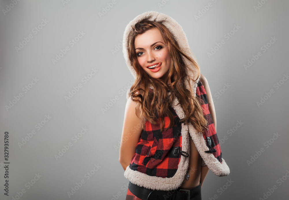 Front view of beautiful girl looking at camera and keeping lips slightly parted. Charming lady wearing stylish checkered costume. Isolated on light lilac background. Concept of style and beauty. Front view of beautiful girl looking at camera and keeping lips slightly parted. Charming lady wearing stylish checkered costume. Isolated on light lilac background. Concept of style and beauty.