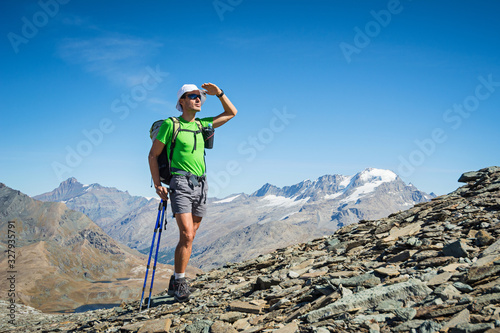 Man trekking in the Alps in a beautiful sunny day. Grand Paradiso National Park. Italy