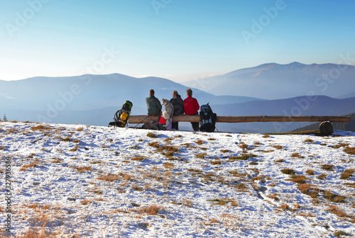 people with dog in mountains photo