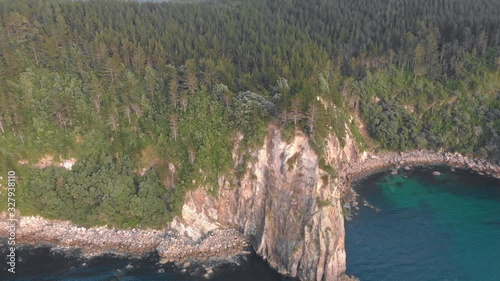 Aerial: Fly-over of a beautiful rocky coastline, New Zealand photo