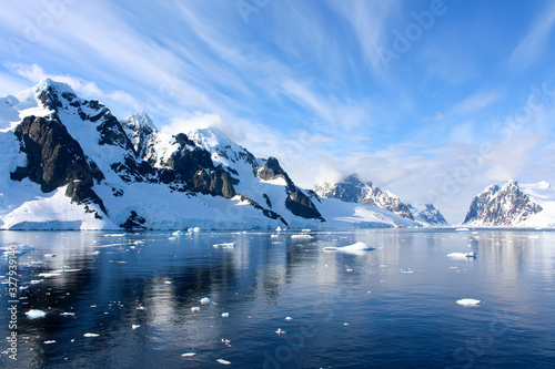 Landscape of snowy mountains and icy shores of the Lemaire Channel in the Antarctic Peninsula, Antarctica