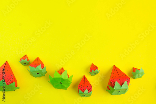 paper strawberries on a yellow background