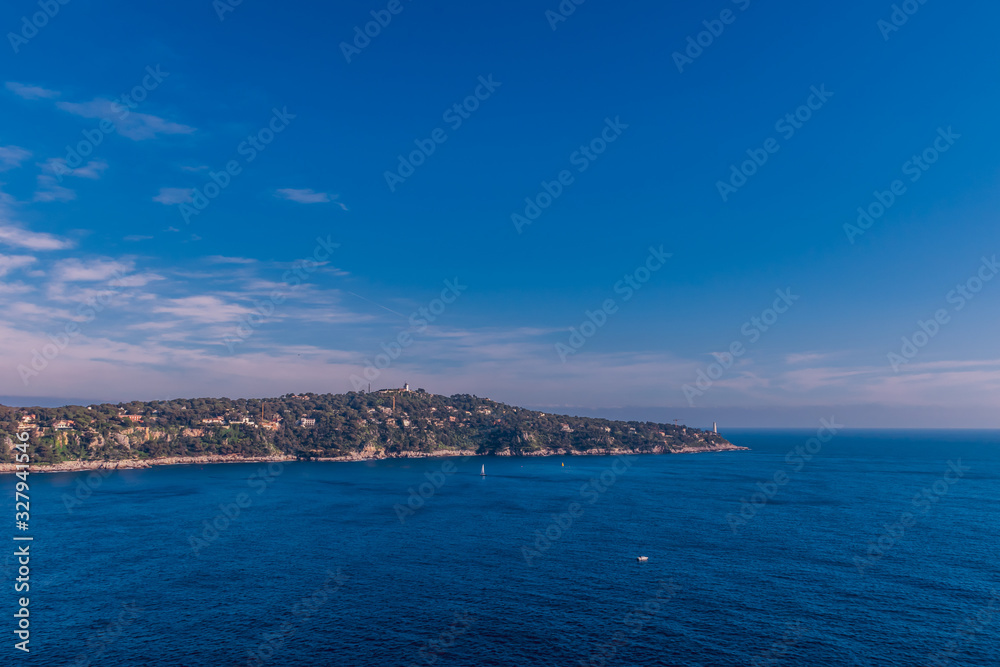 The panoramic view of Saint-Jean-Cap-Ferrat and the Mediterranean Sea's turquoise water during sunset (Provence Côte d'Azur, France)