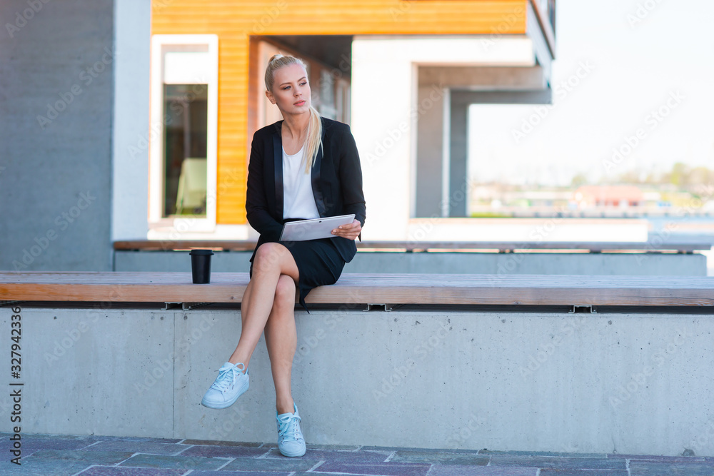 Outdoor photo of young and attractive businesswoman or student. Business and education concept.