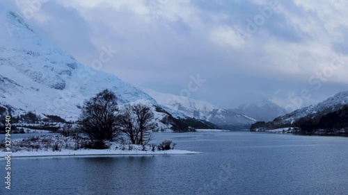 footage of snow falling over loch leven and eilean nam ban, an island in the loch, in the argyll region of the highlands of scotland during winter photo