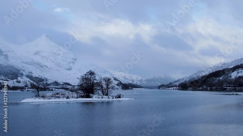 footage of snow falling over loch leven and eilean nam ban, an island in the loch, in the argyll region of the highlands of scotland during winter photo