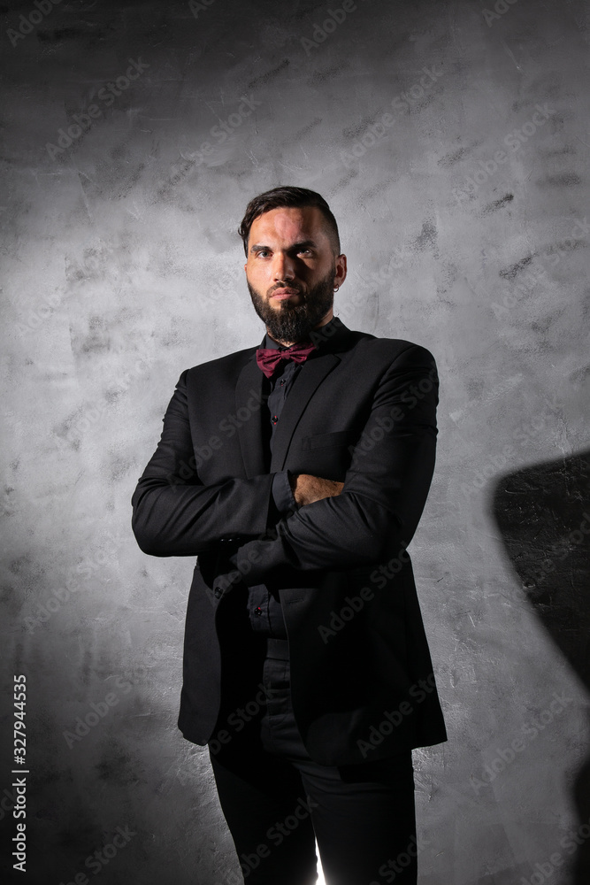 Confident elegant man looking at camera at studio Confident elegant man looking at camera at studio
