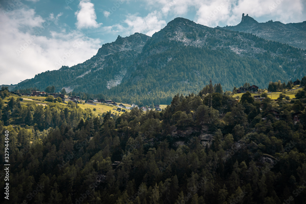 Small village in Switzerland. Traditional swiss landscape. Alps mountains in Switzerland