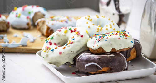 donut, polish donut, classic donut, old-fashioned donut, one donut with icing sugar on a white background, close-up. Copy space. bitten donuts