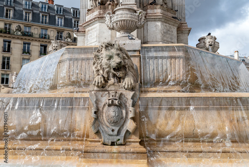 Close-up on a lion ornament of the Fountain of Saint Sulpice in winter - Paris, France photo