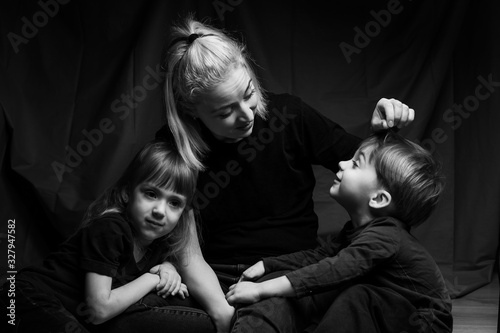 caucasian Family Portrait in Black and White. mom daughter and son. caucasian family with two children