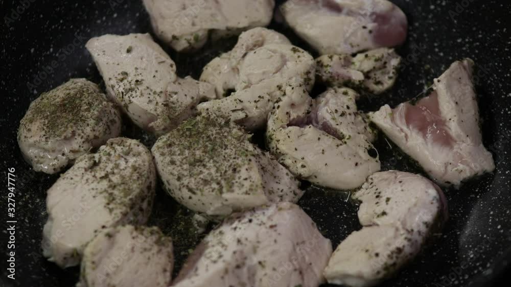 the process of cooking chicken with herbs in a dark pan 4K video the process of cooking chicken with herbs in a dark pan 4K video
