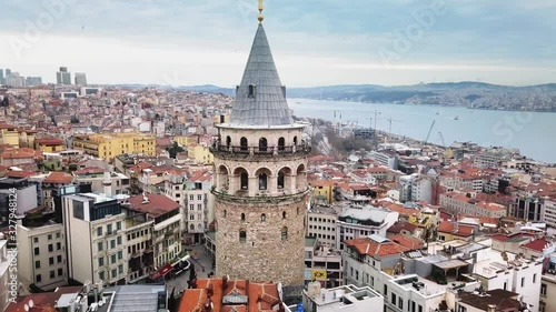 Aerial zoom in. Historical Galata Tower one of the oldest towers in the world, build by Byzantium Emperor Anastasius in 507. Tracking shot photo