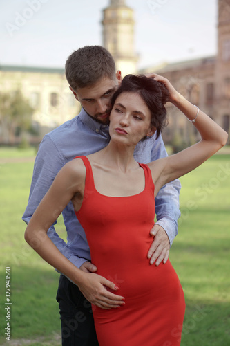Beautiful couple of man and woman against the backdrop of a beautiful park and city architecture. Romantic theme with a girl and a guy. Spring Summer picture relationship, love, Valentine's day © subjob