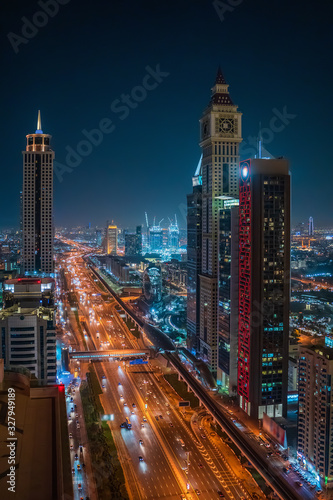Beautiful night Dubai skyline downtown, United Arab Emirates. Aerial view from above of highways with car traffic and skyscrapers buildings.