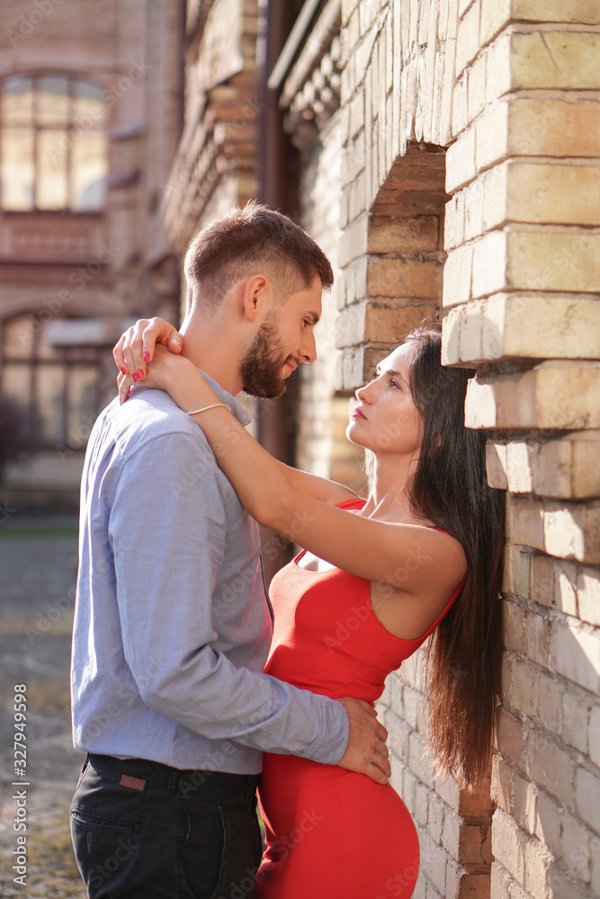 Beautiful couple of man and woman on the background of a wonderful architectural solution. Romantic theme with a girl and a guy. Spring, summer photo relationship, love, Valentine's day Beautiful couple of man and woman on the background of a wonderful architectural solution. Romantic theme with a girl and a guy. Spring, summer photo relationship, love, Valentine's day
