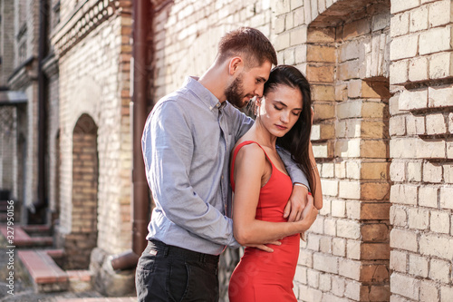 Beautiful couple of man and woman on the background of a wonderful architectural solution. Romantic theme with a girl and a guy. Spring, summer photo relationship, love, Valentine's day