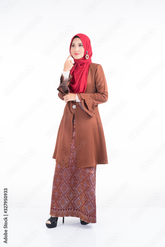 Full length portrait of a beautiful female model wearing a modern kebaya dress and hijab, a lifestyle apparel for Muslim women isolated on white background. Beauty and hijab fashion concept. Full length portrait of a beautiful female model wearing a modern kebaya dress and hijab, a lifestyle apparel for Muslim women isolated on white background. Beauty and hijab fashion concept.